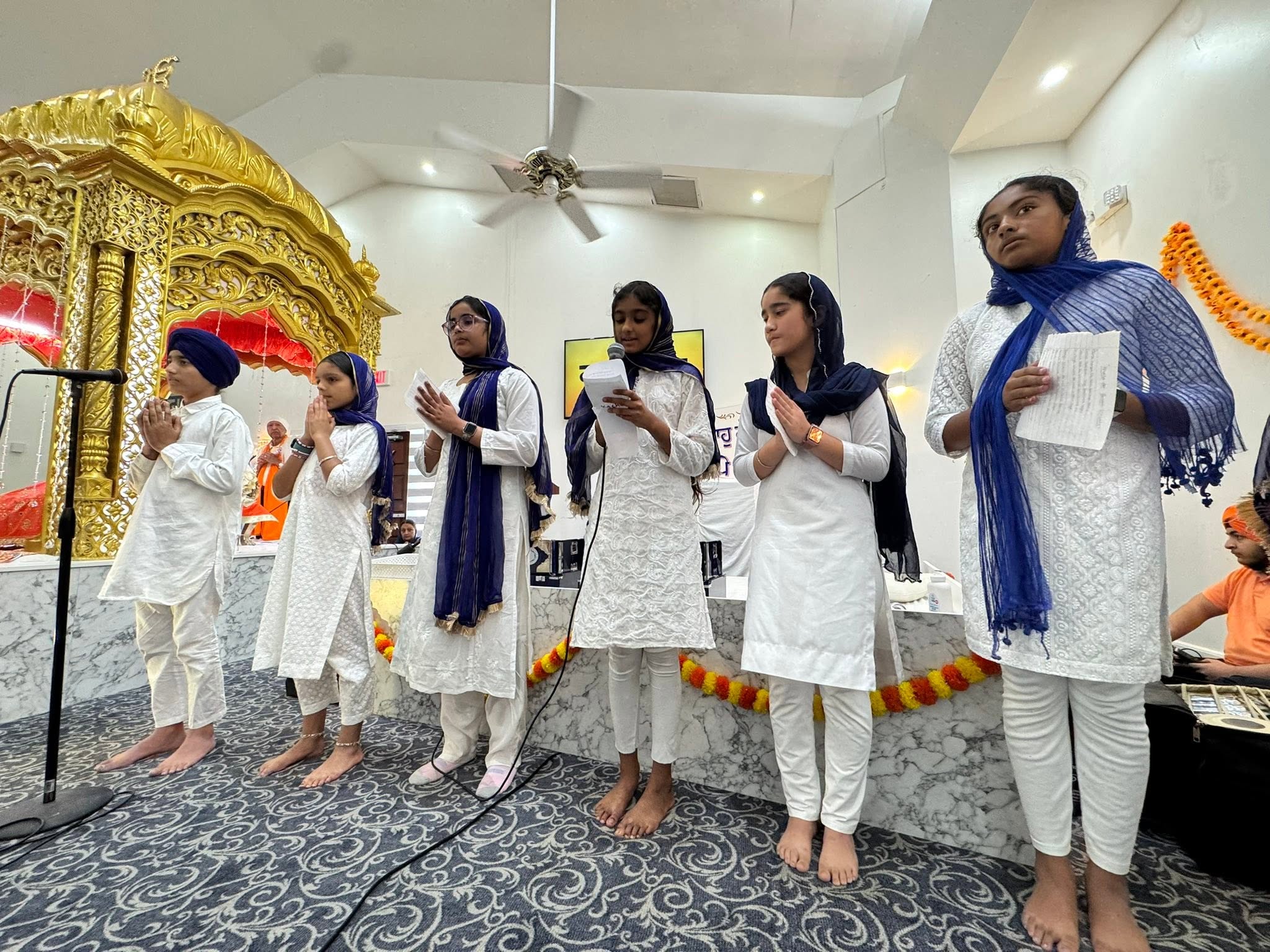 Children standing for Ardas before Guru Granth Sahib Ji