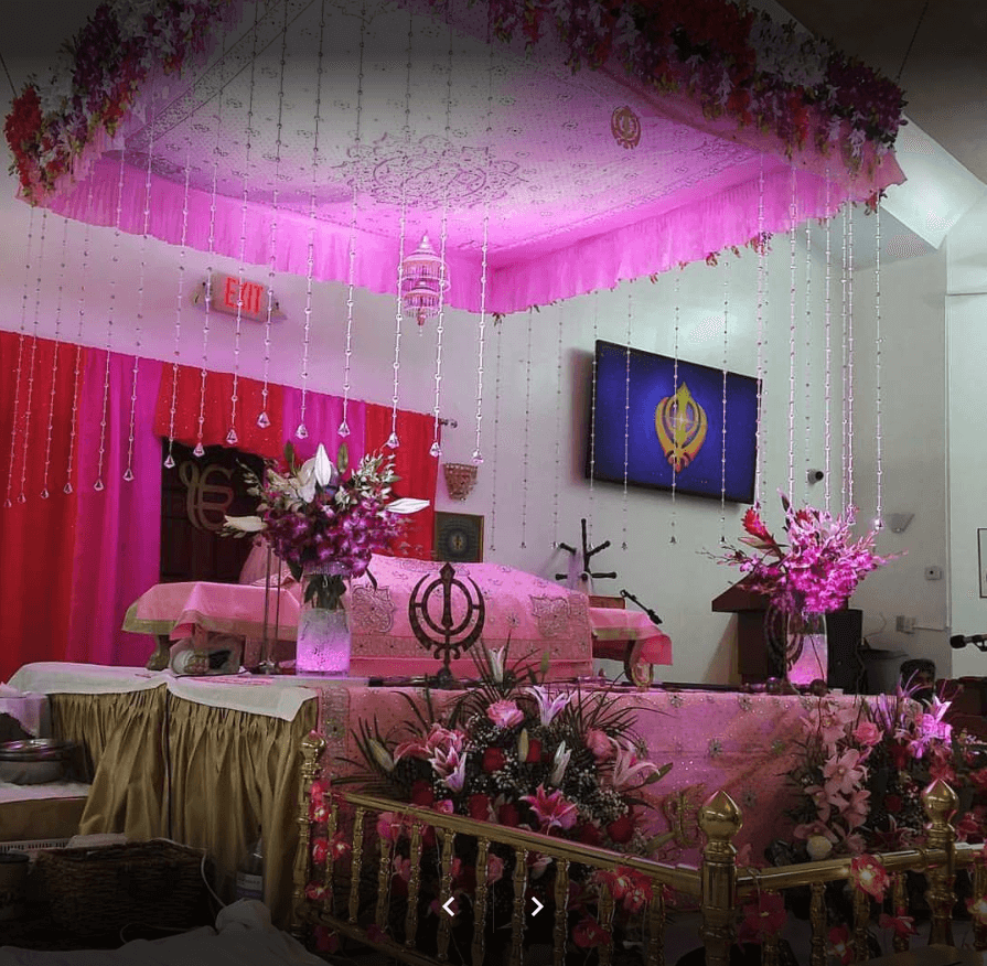 The Palki Sahib beautifully decorated with pink flowers for a Gurpurab celebration