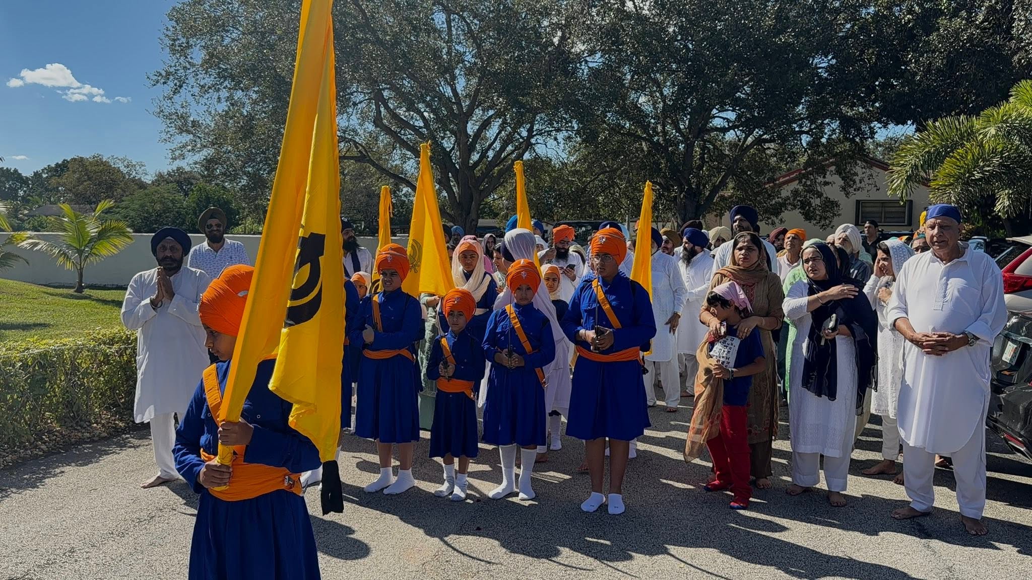 Children carrying Nishan Sahib flags at a Nagar Kirtan